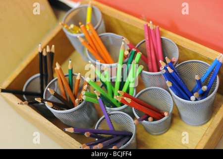 colored pencils in school pots on tray Stock Photo
