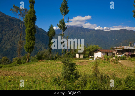 India, Sikkim, Khecheopalri Lake, House above lake with Kanchenjunga range in background Stock Photo