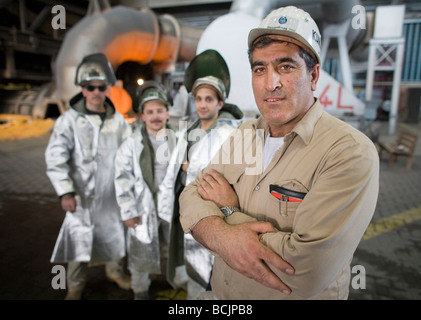 WORKERS WITH PROTECTIVE CLOTHES AT STEELPLANT Stock Photo