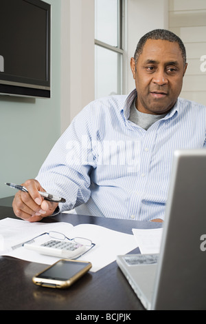 Man doing home finances Stock Photo