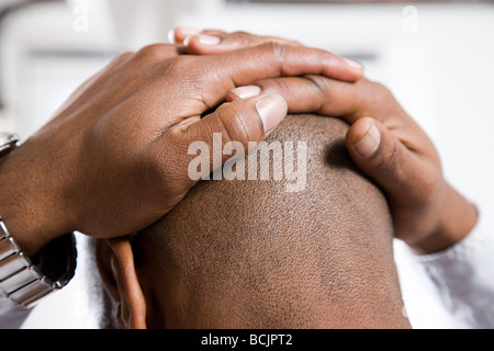 Stressed man with head in hands Stock Photo