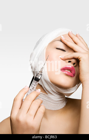 Young woman having cosmetic surgery Stock Photo