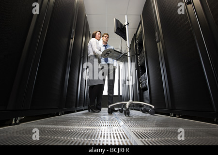 Two computer technicians working on servers Stock Photo