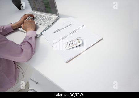 Cropped image of a businesswoman at desk Stock Photo