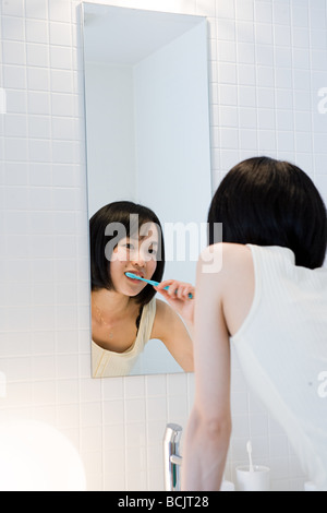 Japanese woman brushing her teeth Stock Photo