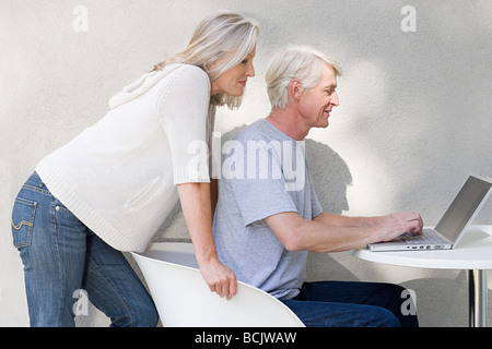 Middle aged couple using laptop Stock Photo