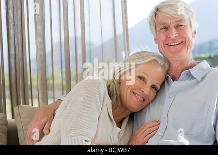 Middle aged couple relaxing on couch together Stock Photo
