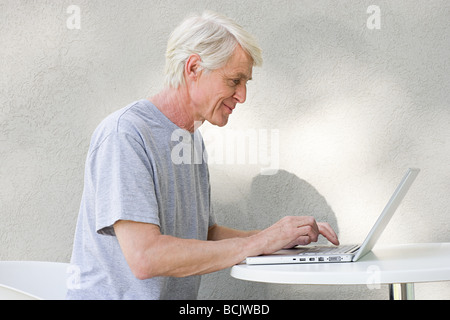 Middle aged man using laptop Stock Photo