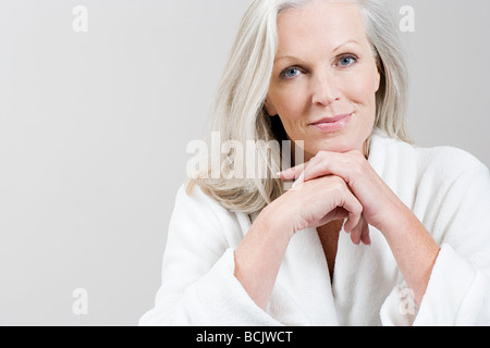 Portrait of Middle aged woman wearing bathrobe Stock Photo