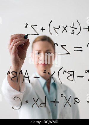 Scientist writing a formula Stock Photo