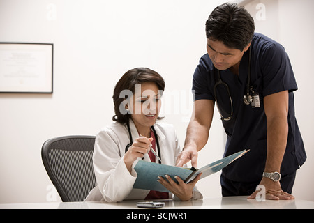 Doctors looking at file Stock Photo