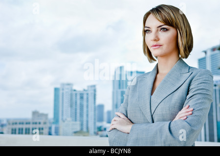 Attractive young business woman looking into distance see other file looking at camera Stock Photo
