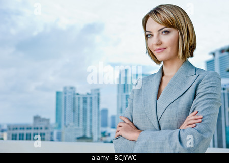 Attractive young business woman looking into camera see other file looking into distance Stock Photo