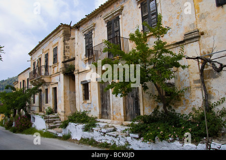 Exterior of houses left abandoned and derelict after 1953 earthquake in village of Assos on  Greek island of Kefalonia Greece GR Stock Photo