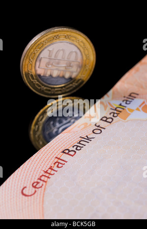 Kingdom of Bahrain Dinar currency banknote and coin arranged on black reflective background Stock Photo
