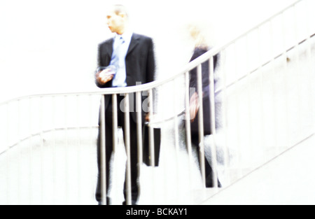Businessman standing behind guard rail, blurred Stock Photo
