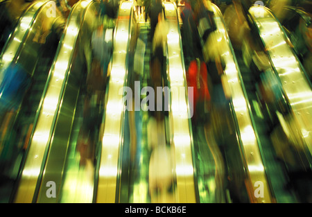 People on escalators, blurred Stock Photo