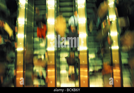 People on escalators, blurred Stock Photo