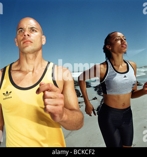 Runners on beach Stock Photo