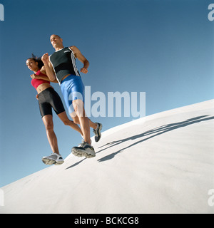 Runners on dunes Stock Photo