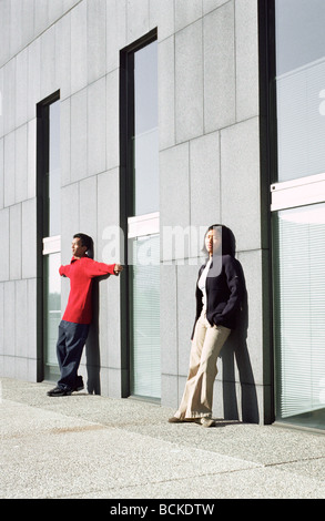 Urban scene, young people leaning against wall Stock Photo