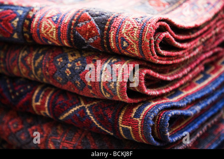 Rugs stacked in market stall