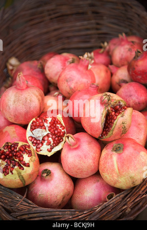 Pomegranate in a basket at market stall Stock Photo