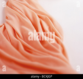 Close-up of crumpled pink cloth isolated on white background. Stock Photo