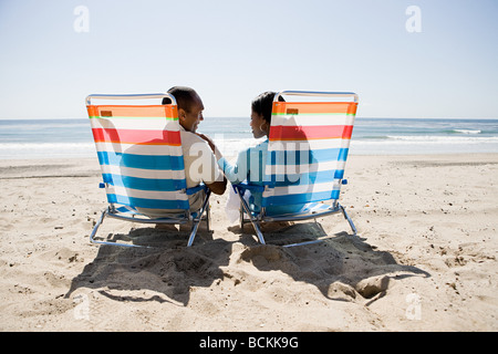 Couple relaxing on a beach Stock Photo