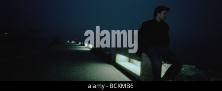 Man walking along road at night, panoramic view Stock Photo