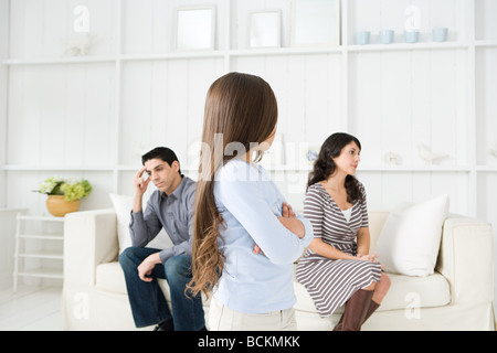 Girl looking at her hostile parents Stock Photo