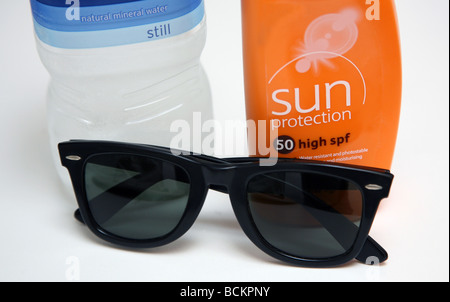 Hot weather precautions - sunblock, water, sunglasses Stock Photo