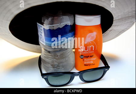 Hot weather precautions - sunblock, water, sunglasses Stock Photo