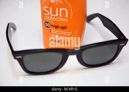 Hot weather precautions - sunblock, water, sunglasses Stock Photo