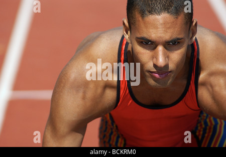 Athlete on clay track Stock Photo