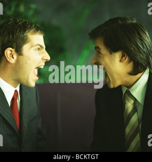 Businessmen yelling face to face Stock Photo