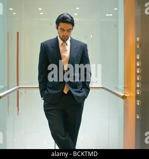 Businessman standing in elevator Stock Photo