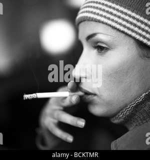Woman smoking, side view Stock Photo