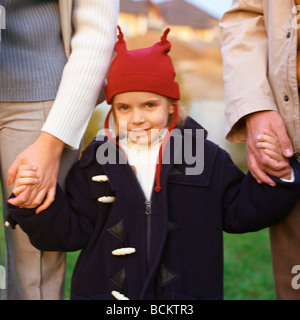 Little girl holding parents' hands Stock Photo