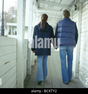 Man and woman walking together in covered walkway Stock Photo