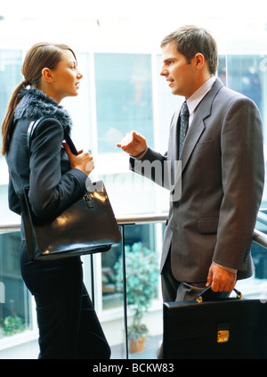 Businessman and businesswoman discussing, side view Stock Photo