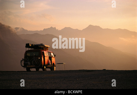 Camper van parked in front of a lake at sunset. Concept van life ...