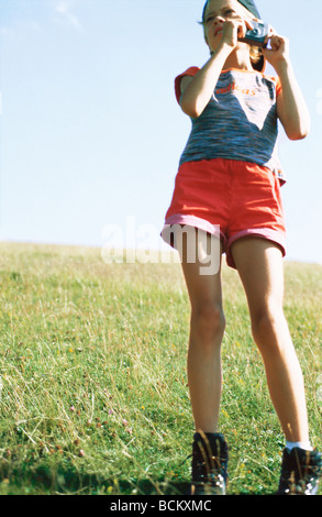 Girl standing with camera Stock Photo