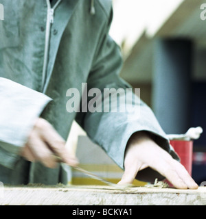 Worker scraping surface Stock Photo