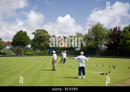 Elderly people playing bowls outdoors on bowling green, Worthing, West Sussex, UK Stock Photo