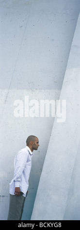 Man standing near concrete wall Stock Photo