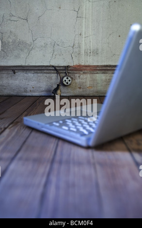 Laptop on hardwood floor Stock Photo