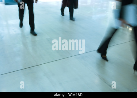 Business people walking, low section, blurred motion Stock Photo