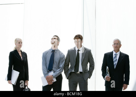 Business people standing in various poses, three quarter length, front view Stock Photo