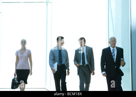 Business people walking toward camera, three quarter length Stock Photo